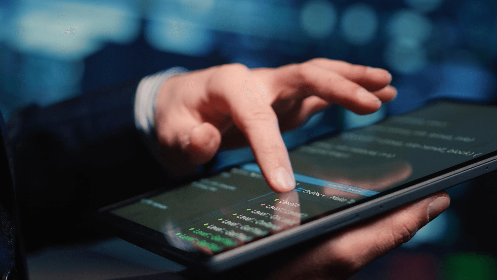 Hand using a smartphone in a dim workspace, representing shadow IT spreading outside approved tools